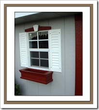 windows with shutters and flower box